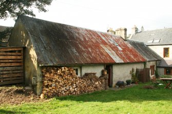 View of rear section, early C19 cottage, corrugated iron roof over thatch; 104 High St. Kingussie.