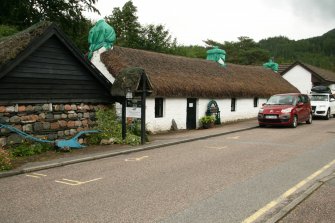  View of single storey 18-19th century thatched cottages; Main Street, Glencoe.