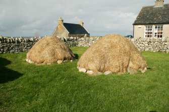 View of thatched outbuildings; 42 Arnol, Lewis.