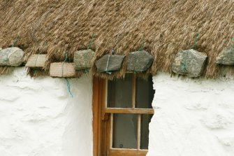 Detail of stone weights over doorway; Tigh na Boireach thatched cottage, Reumisgarry North Uist.