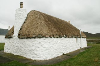 Rear view of thatched cottage and chimney stack; Tigh na Boireach, Reumisgarry, North Uist.