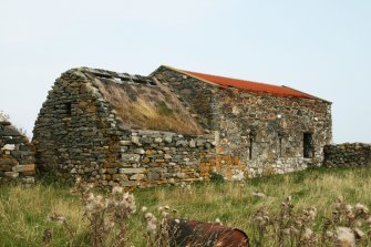 View of 18th century Byre with part damaged thatch roof, part corrugated iron; Ruisgarry, Baile.