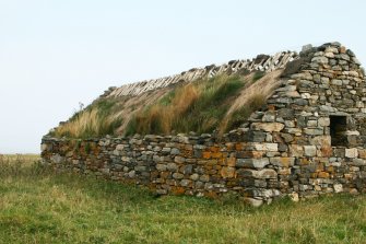 View of byre showing decayed thatch; Ruisgarry, Baile, Berneray.