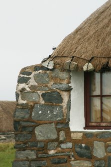 Detail of roof corner and weights above window; probable 19th century cottage; Laimrig Ruadh, Berneray.