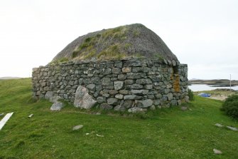 View of outbuilding showing vegetation growth on thatch; 9 Locheport, North Uist.