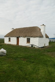 Side view of renovated, marram thatched cottage; Balivanich, Benbecula.