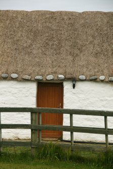 Detail of roof and eaves over doorway;  thatched cottage, Balivanich, Benbecula.