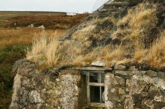 Detail of cottage wall and roof showing general deterioration;  1 Aird Cumhang, Hacklet, Benbecula.