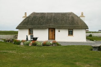 View of renovated thatched probably 19th century cottage; 51 Balgarva, Eochar, South Uist.