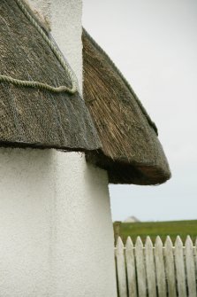 Detail of thatched roof showing rope around chimney stack;  51 Balgarva, Eochar, South Uist.