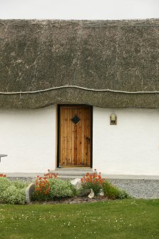 Detail of thatched roof with rope over doorway;  51 Balgarva, Eochar, South Uist.
