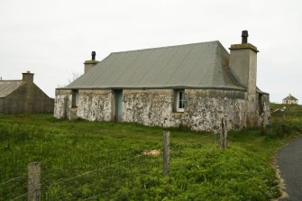 View of probable 19th century cottage with previously thatched roof presently covered in felt; Eochar, Bualadubh, South Uist.