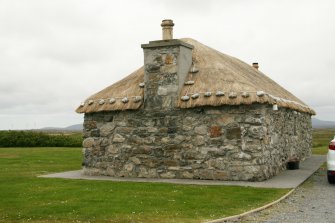 Detail of weighted thatch around chimney stack;  Eochar, 96 Bualadubh, South Uist.