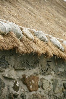 Detail of weighted thatch at eaves;  Eochar, 96 Bualadubh, South Uist.