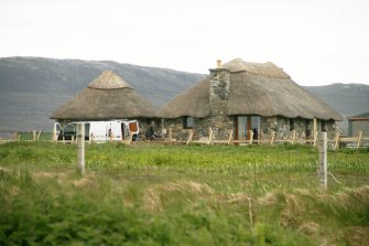 General view of thatched cottage and outbuilding; Cille Pheadair, South Uist.