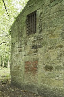 Bonded store, west wall, detail of bricked up opening with barred window above. The bricks are hand made and so early.