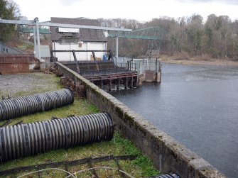 View of hydro-electric power station with footbridge in background.