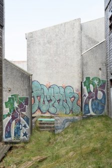 Accommodation block. View of graffiti art from south.