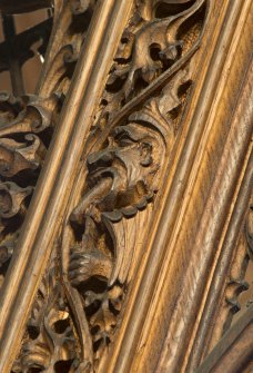 West transept. Detail of carved screen (man eating sausage).