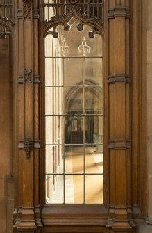 East transept. Glazed screen at south end, view through to east side of nave.