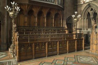 Chancel. Choir stalls from south east.