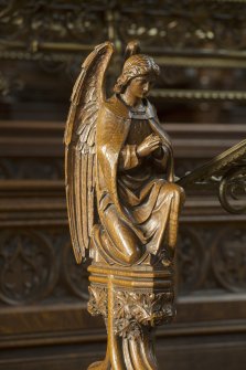 Chancel. Carved angel on end of choir stall.