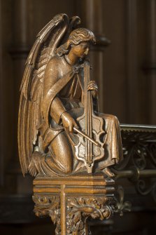 Chancel. Carved angel on end of choir stall.