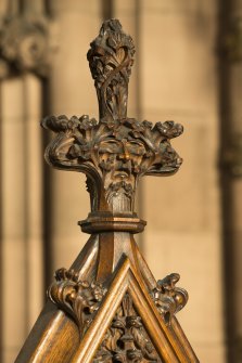 Chancel. Detail of carved face in finial of organ console.
