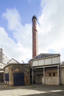 Courtyard. View from north east. Boiler house and chimney. Access to the loading bank on the left and on the right, through the double door, access to Wet Process areas