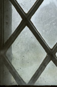 East window. Detail of writing etched on glass. (Image reversed for legibility.) 'The Gencalvie amat'