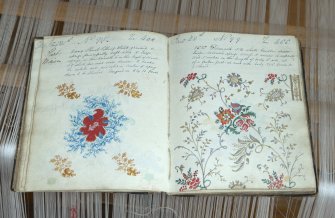 Interior. Jaquard loom in gallery area. View of design book for Jaquard loom from early - mid 19th century shwing elaborate and colourful patterns that could be achieved by the Jaquard loom