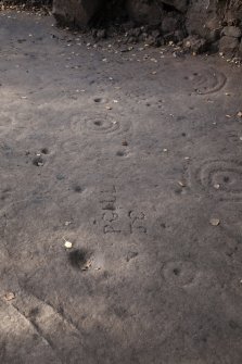 Detail of cup and ring marks and grafitti.