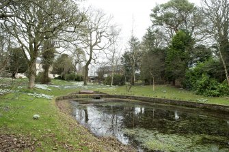 General view of Castlehill Farmhouse gardens and  former curling pond, taken from the south west.