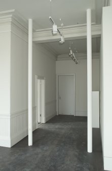 Ground floor, corridor to main exhibition space with columns, view from north