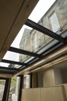 Ground floor, cafe extension, view looking through glazed roof to windows of original building