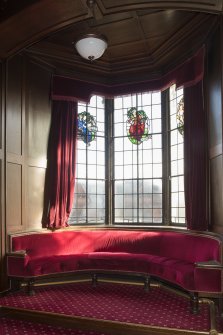 First floor. Committee room 1. View of oriel window with fitted seating Stained glass window depicting Letters, Arts and Science.