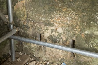 Interior. Ground floor. South wall. Detail of floor joist holes.