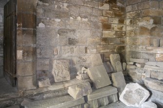  View of carved stones and fragments in ground floor of tower.