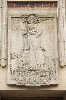East front. Detail of plaque above presbytery entrance.