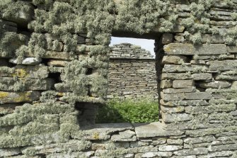 West range, view looking through window on south wall to inside of gable beyond