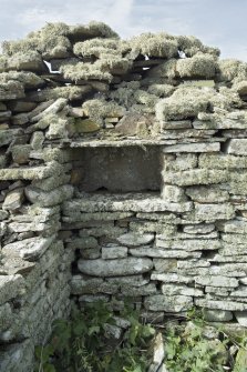 West range, north wall, detail of stone cupboard in north west corner