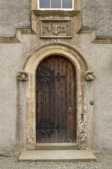 North west entrance with date plaque and rope moulding