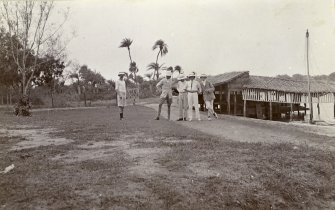 Four men standing on waterside, titled 'Messr Sandeman, Bud, Wilson, and Holt. Madras Boat Club. 21.7.07'. 
PHOTOGRAPH ALBUM NO.116: D M TURNBULL
