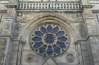 North west front, detail of rose window and carved angels