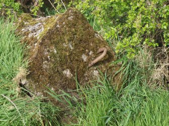 A concrete block with an asymmetrical iron loop