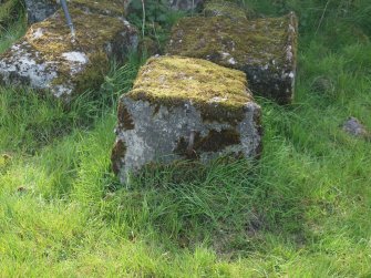 A block with an asymmetrical iron loop in its summit from the NE