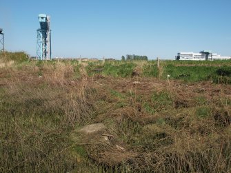 Grass and reed-grown concrete blocks with a winch stone in the foreground