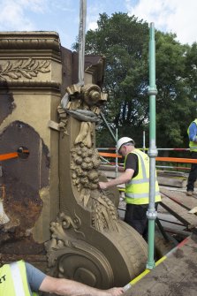 Buttress being removed by crane