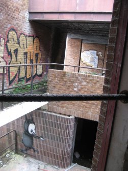 General view of main stairwell with multiple graffiti images.