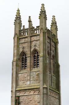 Detail of upper section of tower with louvre windows and finials